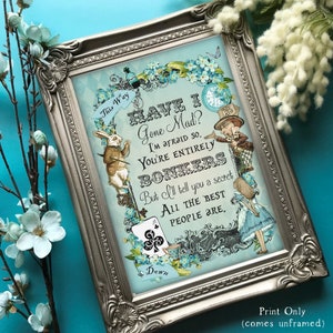 May include: A framed print with a blue background featuring a quote from Alice in Wonderland: "Have I Gone Mad? I'm afraid so. You're entirely bonkers. But I'll tell you a secret. All the best people are."
