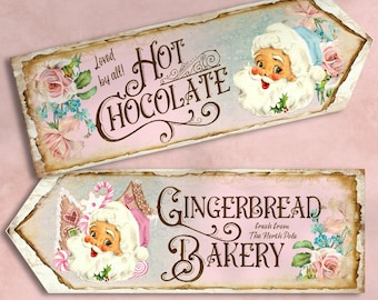 May include: Two vintage-style signs with pink backgrounds and floral accents. The top sign says "Hot Chocolate" with a Santa Claus illustration. The bottom sign says "Gingerbread Bakery" with a Santa Claus illustration and the text "Fresh from the North Pole".