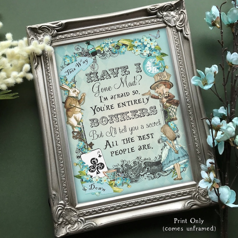 May include: A framed print with a blue background featuring a quote from Alice in Wonderland: "Have I Gone Mad? I'm afraid so. You're entirely bonkers. But I'll tell you a secret. All the best people are."