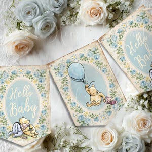 May include: A decorative banner featuring three rectangular panels with vintage-style illustrations of Winnie the Pooh, Piglet, and Eeyore. Two panels display the text Hello Baby in script, while the center panel shows Pooh holding a blue balloon.
