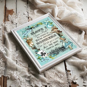 May include: A framed print with a blue background featuring a quote from Alice in Wonderland. The quote reads "Have I Gone Mad? I'm afraid so. You're entirely bonkers. But I'll tell you a secret. All the best people are."