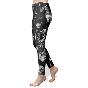 May include: Black leggings with a white Alice in Wonderland print. The print features characters like the Mad Hatter, the Cheshire Cat, and the Queen of Hearts.