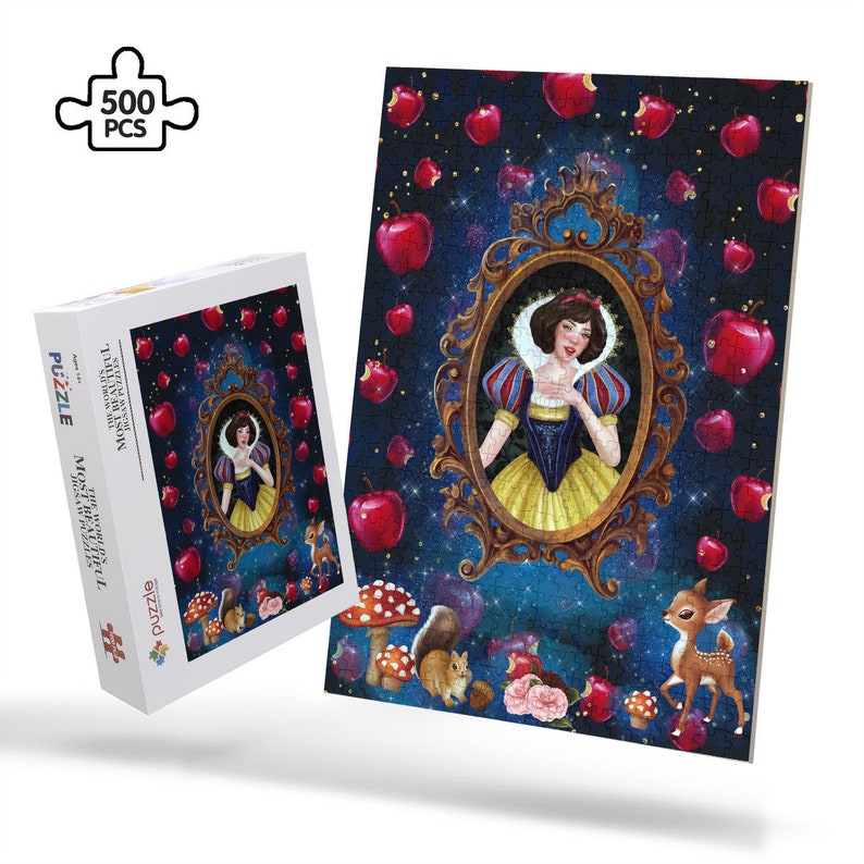 May include: A 500 piece jigsaw puzzle featuring a whimsical illustration of Snow White in a golden frame surrounded by red apples against a dark blue starry background. The puzzle box shows a smaller version of the image.