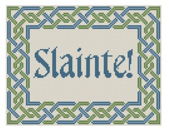 May include: A green and blue Celtic knot border surrounds the word "Slainte!" in a blue font on a beige background.