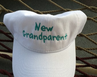 New Grandparent - White Cap with Aqua Marine Lettering- "It's a Girl" on the Back