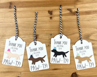 May include: Four white thank you tags with black and white twine. Each tag features a cartoon dog wearing a party hat and the text "Thank you for coming to my paw-ty!"