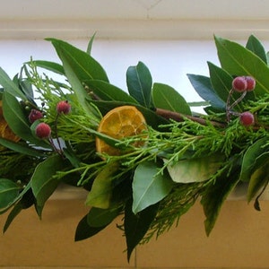 Fresh Christmas garland, mantlepiece. scented dried oranges, Bay leaves, evergreen fir, red berries, cinnamon sticks. Smells divine image 8