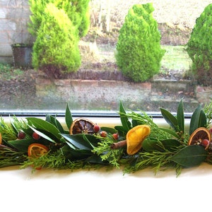 Fresh Christmas garland, mantlepiece. scented dried oranges, Bay leaves, evergreen fir, red berries, cinnamon sticks. Smells divine image 5