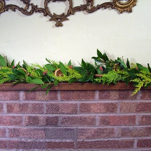 Fresh Christmas garland, mantlepiece. scented dried oranges, Bay leaves, evergreen fir, red berries, cinnamon sticks. Smells divine image 7