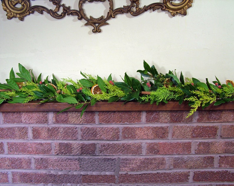 Fresh Christmas garland, mantlepiece. scented dried oranges, Bay leaves, evergreen fir, red berries, cinnamon sticks. Smells divine image 7