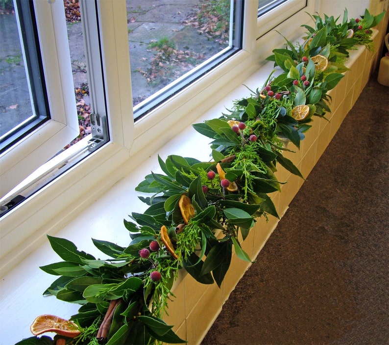 Fresh Christmas garland, mantlepiece. scented dried oranges, Bay leaves, evergreen fir, red berries, cinnamon sticks. Smells divine image 6