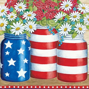 May include: Three mason jars decorated in red and white stripes and blue with white stars, filled with red, white, and blue flowers. The jars are sitting on a wooden surface with a blue and white patterned border with red stars.