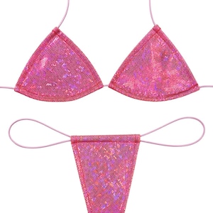 May include: A two-piece bikini set featuring a triangle top and a thong bottom, both crafted from a shimmering, metallic pink fabric with a fine mesh texture. The set includes thin, matching pink cord straps for ties at the neck and sides.