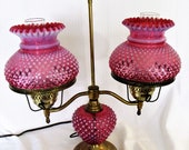 Fenton Cranberry Hobnail Trio Glass Student Lamp 23 quot and was made in the 1950 39 s. The Lamp has the original metal plated stand and globes.