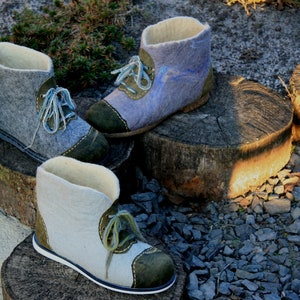 May include: Three pairs of felt boots with green and blue accents. The boots are made of wool and have a soft, comfortable feel.