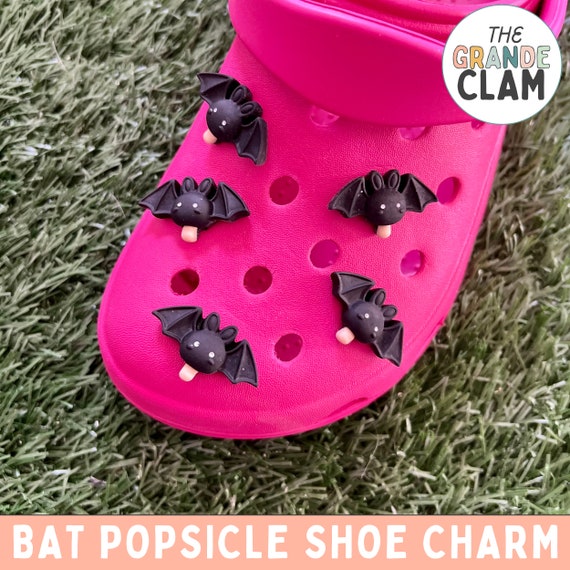 A tiny handmade bat holding a popsicle as a shoe charm — chaotic, specific, and wildly lovable with 103 favorites proving the cult appeal.