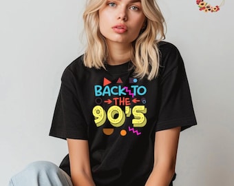 May include: A black t-shirt with a colorful graphic that says "Back to the 90's". The graphic features a yellow 90's with colorful geometric shapes around it.