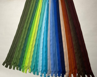 Set of 24 -14 inch ,#3 nylon coil YKK zippers. Assorted Blues, Greens, & Browns