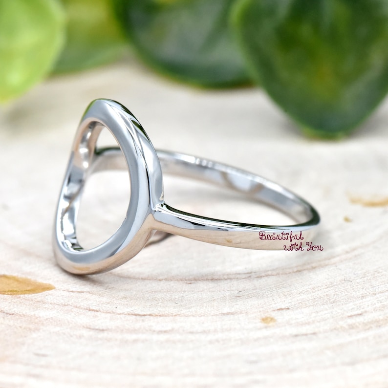 May include: A silver ring with a large open circle design. The ring is engraved with the words "Beautiful with You".