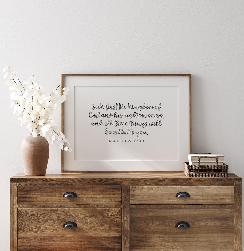 This mockup shows what this unframed Matthew 6 33 Bible verse poster could look like with a mat and frame. It has a white background and gray text. It says seek first the kingdom of God and his righteousness and all these things will be added to you.