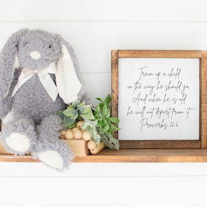 This is a mockup of what this Proverbs 22:6 unframed poster could look like framed in a nursery or kids room. This Proverbs 22:6 unframed print says, Train up a child in the way he should go, and when he is old, he will not depart from it.
