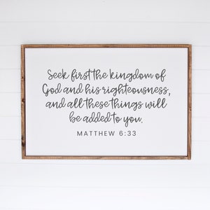 This mockup shows what this unframed Matthew 6 33 Bible verse poster could look like in a 24x36 inch frame. It has a white background and gray text. It says seek first the kingdom of God and his righteousness and all these things will be added to you