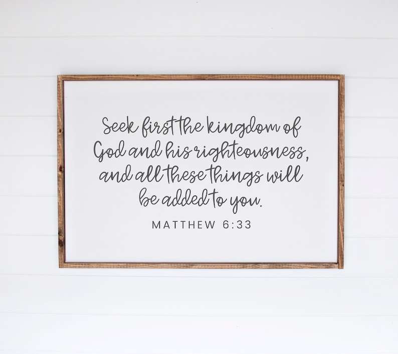 This mockup shows what this unframed Matthew 6 33 Bible verse poster could look like in a 24x36 inch frame. It has a white background and gray text. It says seek first the kingdom of God and his righteousness and all these things will be added to you
