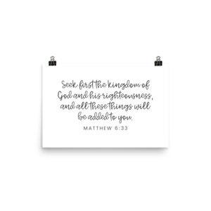 This 12x18 inch bible verse poster says Seek first the kingdom of God and his righteousness and all these things will be added to you. Matthew 6 33. The background is white and the text is gray and mostly in a cursive font.