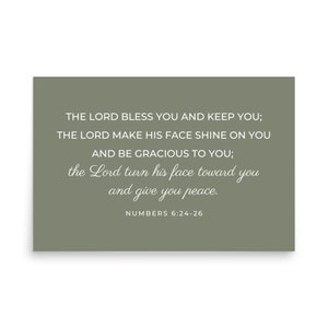 May include: A sage green background with white text that reads "THE LORD BLESS YOU AND KEEP YOU; THE LORD MAKE HIS FACE SHINE ON YOU AND BE GRACIOUS TO YOU; the Lord turn his face toward you and give you peace. NUMBERS 6:24-26"