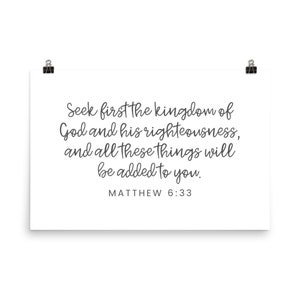 This 24x36 inch bible verse poster says Seek first the kingdom of God and his righteousness and all these things will be added to you. Matthew 6 33. The background is white and the text is gray and mostly in a cursive font.