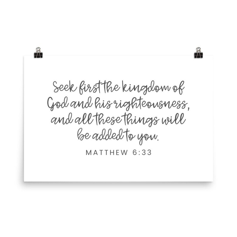 This 24x36 inch bible verse poster says Seek first the kingdom of God and his righteousness and all these things will be added to you. Matthew 6 33. The background is white and the text is gray and mostly in a cursive font.