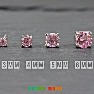 May include: Four pairs of pink cubic zirconia stud earrings in sizes 3mm, 4mm, 5mm, and 6mm. Each earring is set in a silver-colored metal. The text "3 MM", "4 MM", "5 MM", and "6 MM" is displayed below each pair. The logo "JEWELRY SEASON" is at the bottom.