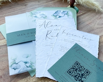 May include: A wedding invitation suite with a green and white color scheme. The invitation features a watercolor illustration of eucalyptus leaves. The RSVP card has a QR code and the text "Please RSVP no later than 01.04.23".