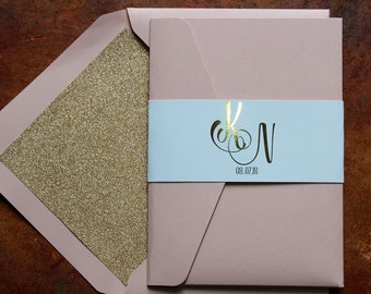 Elegant blush pink, white and gold foil pocketfold wedding invitations with glitter lined blush envelopes