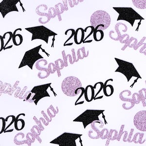 May include: Confetti with a graduation theme, featuring black mortarboards, the year "2026", and the name "Sophia" in a glittery purple script. The confetti is scattered on a white background, with purple glitter circles.
