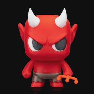 May include: A red devil figurine with white horns, angry eyes, and a small orange pitchfork. The figure is wearing gray shorts and has a stern expression. The background is black.