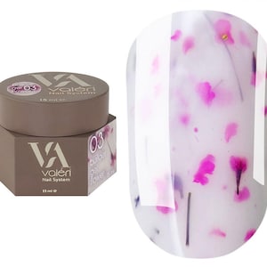 May include: A 15 ml jar of Valéri Nail System builder gel in shade 03 flower, featuring a brown hexagonal container with white text. Beside it is a nail swatch showing a translucent milky white gel base embedded with small pink flower petals.