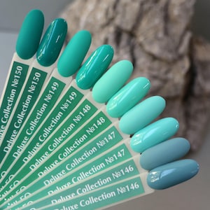 May include: A colour chart of teal, blue, and green nail polish shades. The chart is labelled with the brand name "Deluxe Collection" and the shade numbers 146, 147, 148, 149, and 150.