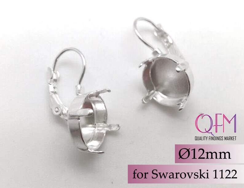 May include: Silver earring settings for 12mm round stones. The settings are designed to fit Swarovski 1122 crystals.  The earrings have a lever back closure.