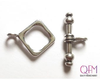 May include: A silver-toned toggle clasp set consisting of a square-shaped loop with a small attachment ring and a T-bar component featuring rounded ends and a central attachment loop. The text QFM QUALITY FINDINGS MARKET is visible in the corner.