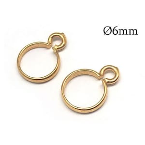 May include: Two gold-colored metal jump rings, each featuring a circular loop with an attached smaller connector loop at the top. The text Ø6mm is visible in the upper right corner, indicating a diameter of 6mm for these jewelry components.
