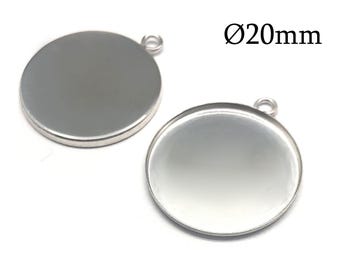 May include: Two silver-colored circular pendant trays with a smooth, flat surface and a small loop at the top for attachment. Each piece has a diameter of 20mm as indicated by the text Ø20mm. The metal components feature a clean, metallic finish.