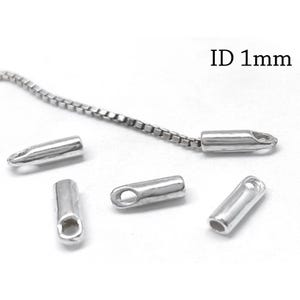 May include: Four silver-toned cylindrical cord ends with a loop at one end, each featuring an ID of 1mm. One cord end is attached to a thin silver-toned box chain. The components have a smooth, metallic finish and are arranged on a plain surface.