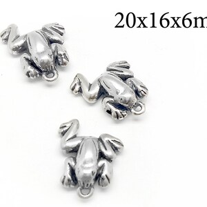 May include: Three silver frog charms with a loop for attaching to jewelry. Each charm measures 20x16x6mm.