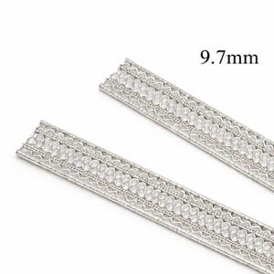 May include: Two silver-colored, decorative metal strips with an openwork design. Each strip is 9.7mm wide and features a repeating pattern of interconnected shapes. The strips are ideal for jewelry making or craft projects.