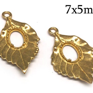 May include: Two gold-tone leaf-shaped pendant settings with oval-shaped bezels, measuring 7mm by 5mm.