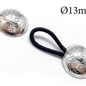 May include: Two silver hair tie accessories with floral patterns. One is attached to a black elastic band. The diameter is 13mm. The accessories are on a white background.