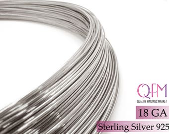 May include: A coil of 18 gauge sterling silver wire, 925 purity. The wire is silver in color and is coiled tightly together. The text "QFM Quality Findings Market" and "18 GA Sterling Silver 925" is visible in the image.