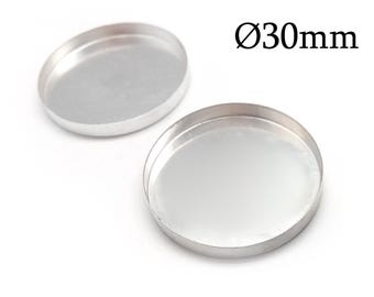 May include: Two circular silver-colored metal trays with raised edges, each featuring a smooth, reflective interior surface. The text Ø30mm is printed in black near the upper right corner, indicating a diameter of 30 millimeters for the items.