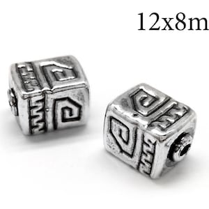 May include: Two silver cube beads with a geometric design, measuring 12x8mm.